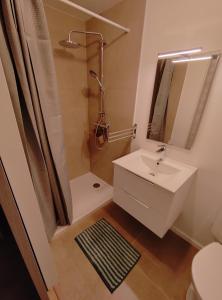 a bathroom with a white sink and a shower at OLOO Habitat - Le 3 in Lure