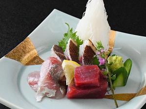 a white plate topped with different types of food at Hotel Daisen Shirogane in Daisen