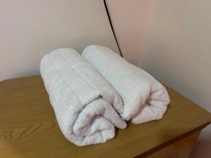 two towels sitting on top of a wooden table at Comfortable with Private Garage and Excellent Location Rb in Riobamba +17 photos