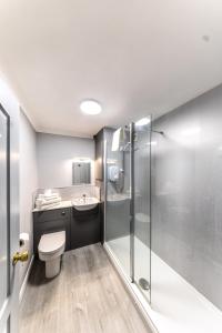 a bathroom with a toilet and a shower at Littleover Lodge Hotel in Derby +56 photos