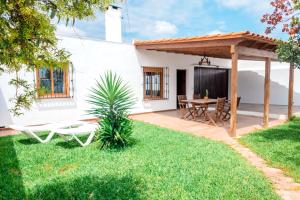 a backyard with a wooden pergola and a table at Calma house Zahora in Zahora