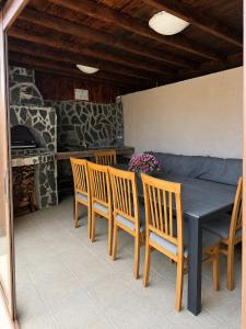 a dining room with a table and chairs and a fireplace at Helena Guest House - Pool & Sea View in Balchik +25 photos