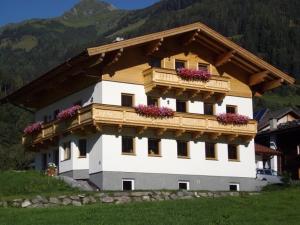 a building with flower boxes on the top of it at Stapfgut in Rauris