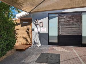 a door to a building with a sign on it at Villa Mariss Guesthouse in Kraaifontein