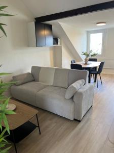 a living room with a couch and a table at L'Atelier 37 - Centre Tours in Tours