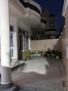 a building with potted plants in a courtyard at Stay Royal Imperial in Jammu