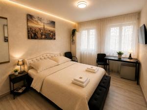 a bedroom with a large bed and a desk at Modern Living Apartment Hotel in Nuremberg