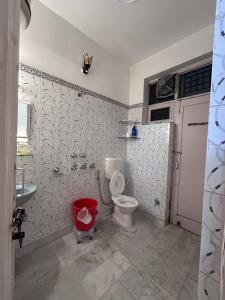 a bathroom with a toilet and a sink at Stay Royal Imperial in Jammu +28 photos