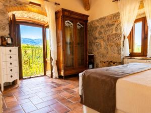 a bedroom with a bed and a large window at La quercia B&B in Abbateggio