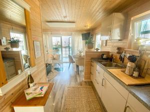 a kitchen with a sink and a counter top at Hausboot - Yara in Heiligenhafen +14 photos