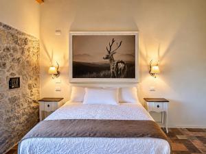 a bedroom with a bed with a picture of a deer at La quercia B&B in Abbateggio