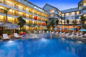 a hotel with a large swimming pool in front of a building at GYTf in Cairo