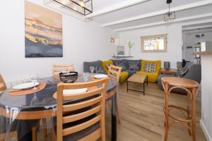 a dining room and living room with a table and chairs at Maison Ty Bihan Sioul in Sarzeau +11 photos