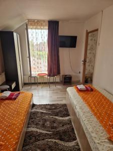a hotel room with two beds and a window at apartament maia 2 in Turda