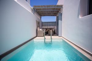 a swimming pool in the middle of a house at Whisper Villa Mykonos in Ano Mera