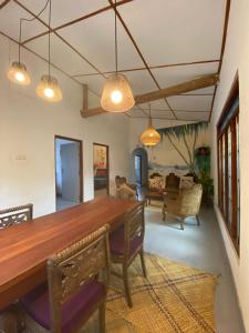 a dining room with a wooden table and chairs at Indiana villa Koggala in Koggala