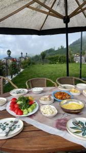 a wooden table with plates of food on it at Villa Deluxe Panorama 61 in Trabzon
