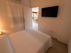 a bedroom with a bed and a television on the wall at NEW 2026 - Villa Rafael in Porto Rafael +23 photos