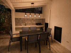 a dining room with a table and chairs at NEW 2026 - Villa Rafael in Porto Rafael