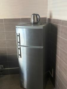 a refrigerator with a tea kettle on top of it at Scaramella room s in Salerno