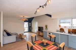 a kitchen and living room with a table in a room at Le Rockin' Chair in Surzur