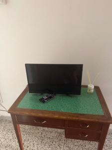 a flat screen tv sitting on top of a wooden table at Scaramella room s in Salerno