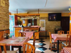 a restaurant with tables and chairs and a kitchen at Villa Kristal Hotel in Budapest