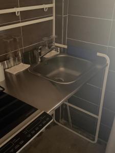 a stainless steel sink in a small kitchen at Scaramella room s in Salerno +12 photos