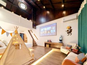 a living room with a bed and a tv at 瓦述loft别院 in Zhangjiajie