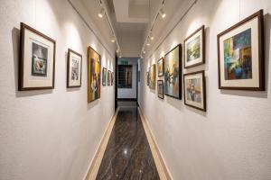a hallway with a bunch of pictures on the walls at Fabhotel Namaskar - Nr Udayagiri and Khandagiri caves in Bhubaneshwar