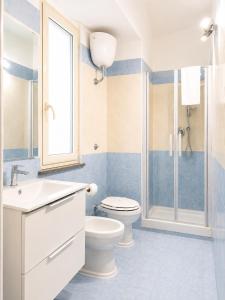 a bathroom with a toilet and a sink and a shower at Casa Corallium in Torre del Greco +51 photos