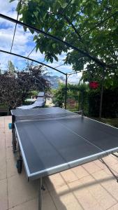 a ping pong table sitting on top of a patio at Les Freds in Ventavon