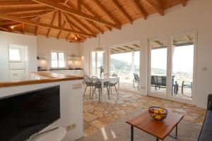 a kitchen and living room with a table and chairs at Philia-Modern Living with Panoramic Sea View in Kotrónion +24 photos