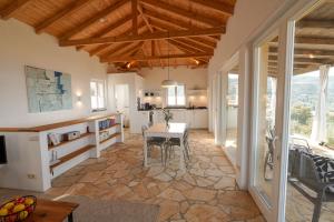 a kitchen and dining room with a table at Philia-Modern Living with Panoramic Sea View in Kotrónion