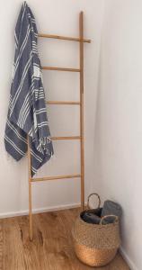 a towel hanging on a wall next to a basket at Philia-Modern Living with Panoramic Sea View in Kotrónion