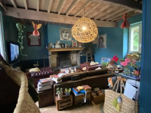 a living room with a couch and a fireplace at Venez Dormir chez Nous Dans Les BaRoNNieS ! Dans notre Caravane CARavelaiR 1979 in Labastide