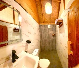 a bathroom with a sink and a toilet and a shower at Aresona Cliff House in Bira