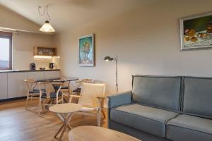 a living room with a couch and a table at Olivi1948 - Boutique Guest House in Usúrbil