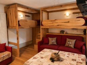 a living room with a couch and a loft bed at Le Petit Refuge in La Thuile