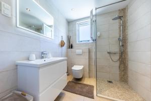 a bathroom with a toilet and a sink and a shower at NIMA Cozy Stay Mlini in Mlini +56 photos