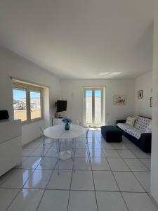 a living room with a table and a couch at Capresella luxury apartment in Capri