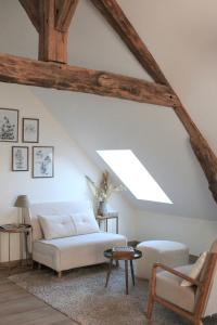 a living room with a white couch and a skylight at MAISON MOZ entre Chambord & Cheverny in Fontaines-en-Sologne