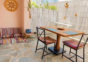 a wooden table and two chairs in a room at Votsalon Beach House - 30 meters from Alykes Beach in Katastárion