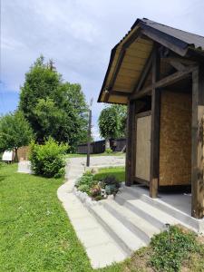 a small building with a door in a yard at Glamping Gradiško in Nova Vas