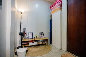 a hallway with a toilet in a room with a door at Staycation by ALCD in San Mateo +31 photos