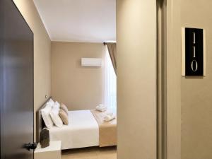 a bedroom with a bed with towels on it at Hotel Santuario Pompei in Pompei