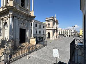 a large building with a clock tower in a street at Hotel Santuario Pompei in Pompei