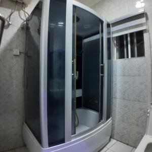 a shower with a glass door in a bathroom at Hotel 101 & Apartments in Karsana +28 photos
