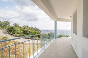 a balcony with a view of the ocean at Perseus in Cape Sarakiniko in Argostoli