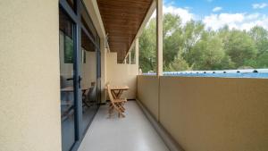 a balcony with a view of a swimming pool at Qinxiang Pavilion Hotel in Dunhuang